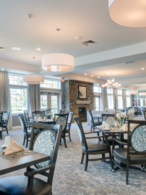 Bright, spacious dining area with elegant seating, soft lighting, and a welcoming fireplace.