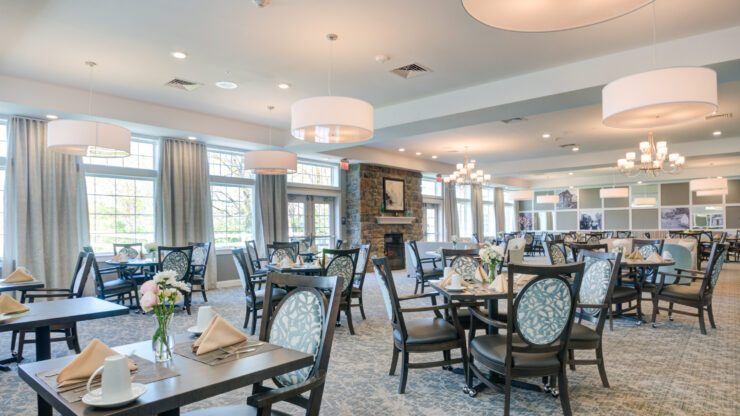 Bright, spacious dining area with elegant seating, soft lighting, and a welcoming fireplace.