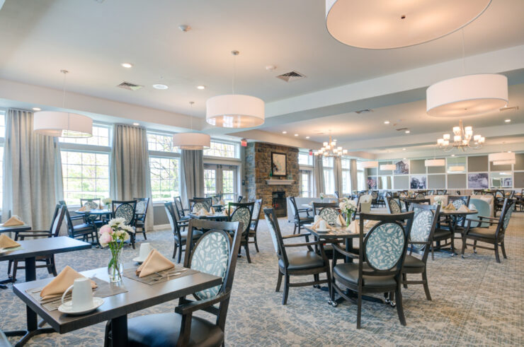 Bright, spacious dining area with elegant seating, soft lighting, and a welcoming fireplace.