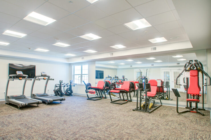 Bright, spacious fitness room with modern equipment fostering health and community wellness.