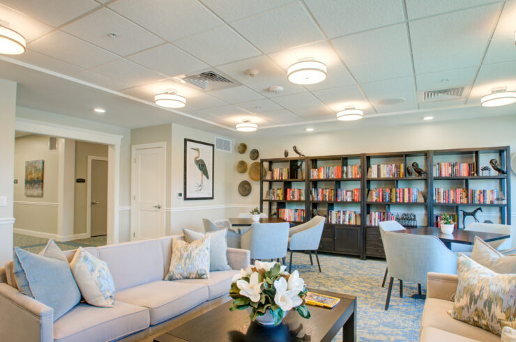 Bright library with comfortable seating, bookshelves, and a welcoming atmosphere for community gatherings.