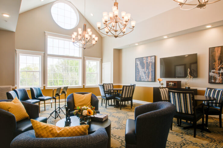 Bright, inviting lounge with comfortable seating, natural light, and a welcoming community atmosphere.