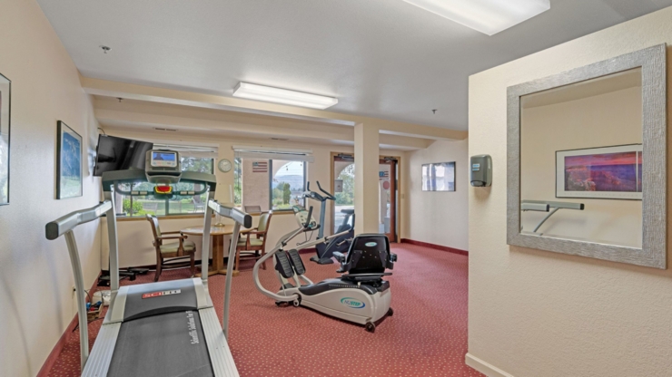 A welcoming fitness area with modern equipment, bright natural light, and a friendly atmosphere.