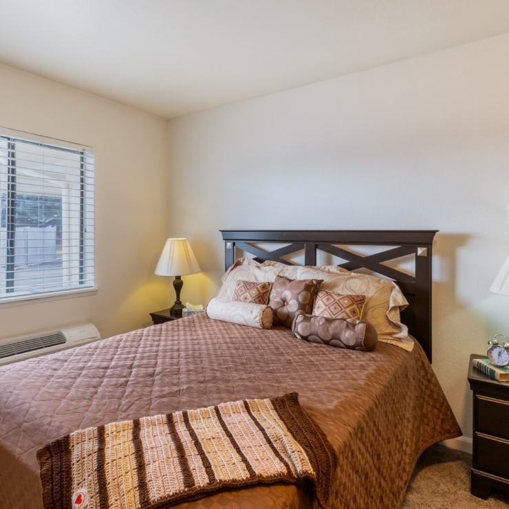 A warm, inviting bedroom designed for comfort, featuring a plush bed and soft lighting for relaxation.