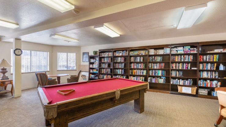 A cozy activity room filled with books and games, inviting residents to relax and connect.