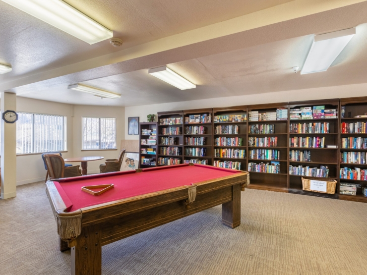 A cozy activity room filled with books and games, inviting residents to relax and connect.