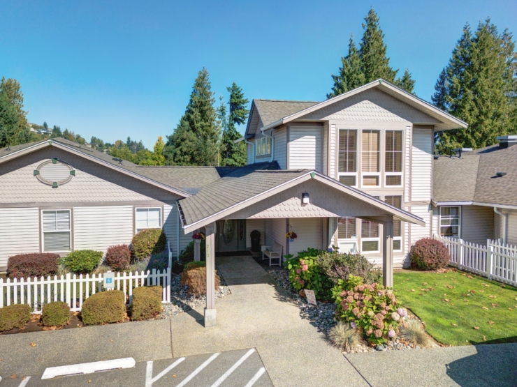 A welcoming entrance surrounded by lush greenery, inviting residents to a warm, community-focused home.