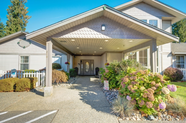 Welcoming entrance surrounded by vibrant flowers, offering a serene atmosphere for the community.