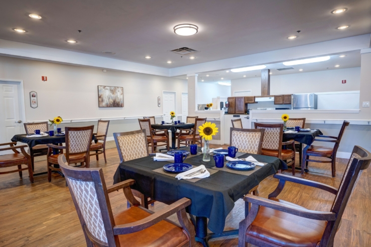 Bright and inviting dining area, fostering community with cheerful sunflowers and thoughtful table settings.