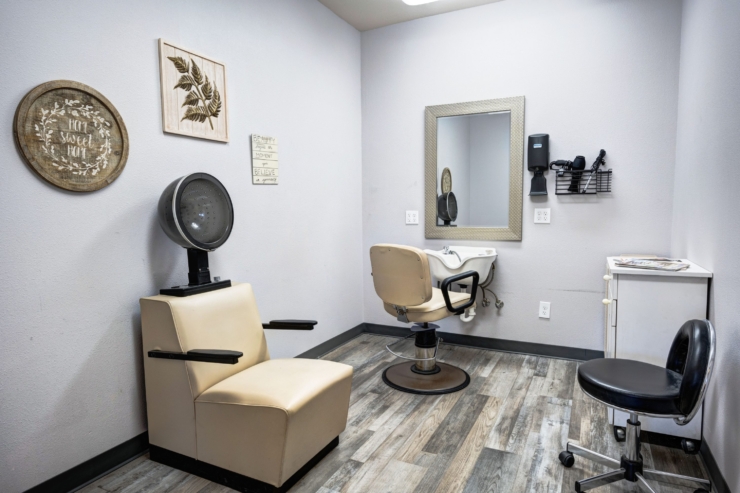 A charming salon space designed for relaxation, featuring warm decor and comfortable seating.