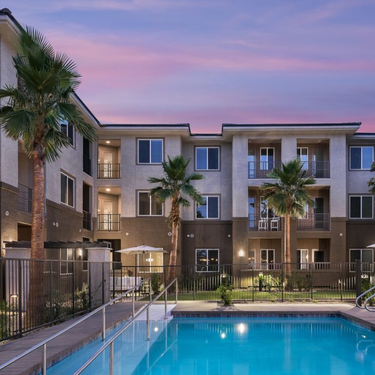 A serene poolside setting, surrounded by inviting palm trees and welcoming balconies, fosters community and comfort.