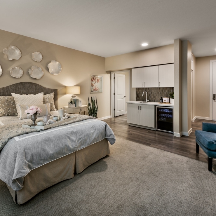 A serene bedroom featuring elegant decor, inviting furnishings, and a warm, welcoming atmosphere.
