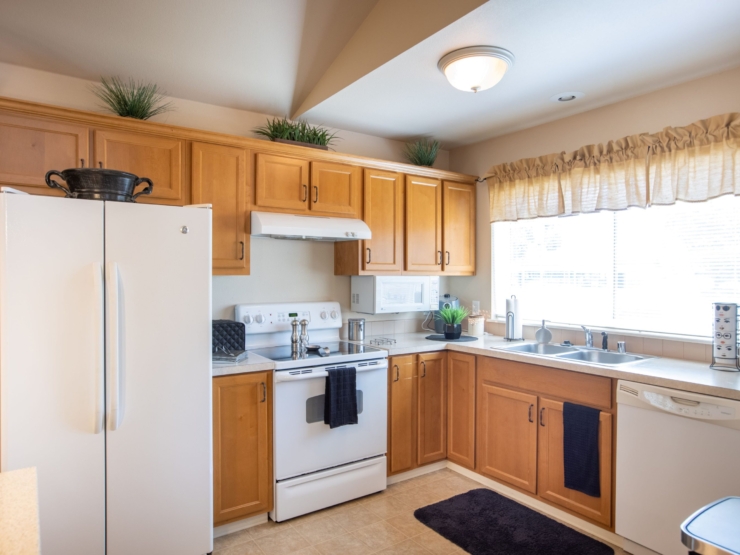 A bright, inviting kitchen with warm wood cabinetry, perfect for shared meals and community gatherings.