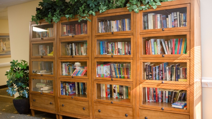 A cozy library corner filled with books, inviting a sense of community and comfort for all residents.