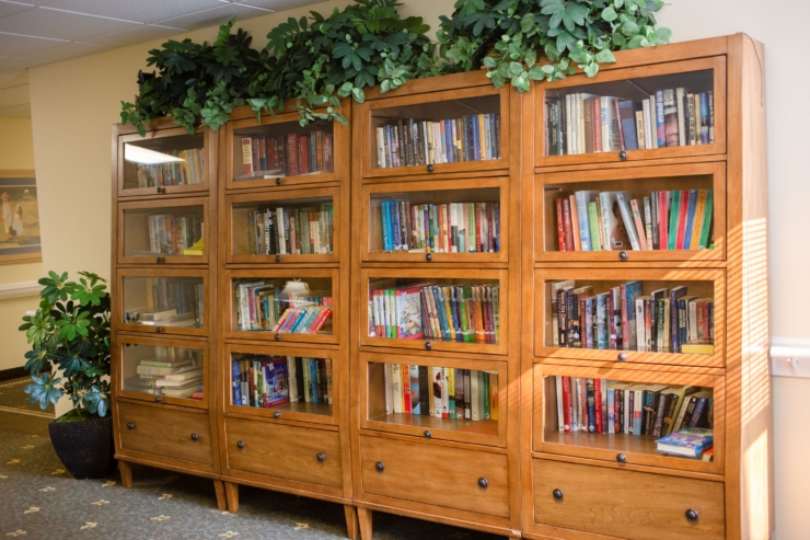 A cozy library corner filled with books, inviting a sense of community and comfort for all residents.