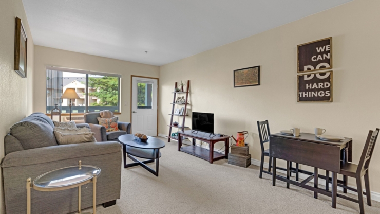 A cozy, inviting living space featuring comfortable seating, warm decor, and natural light, perfect for community gatherings.