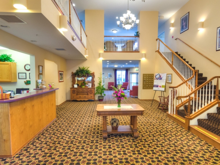 A welcoming lobby featuring warm colors, floral decor, and comfortable seating, promoting community and connection.