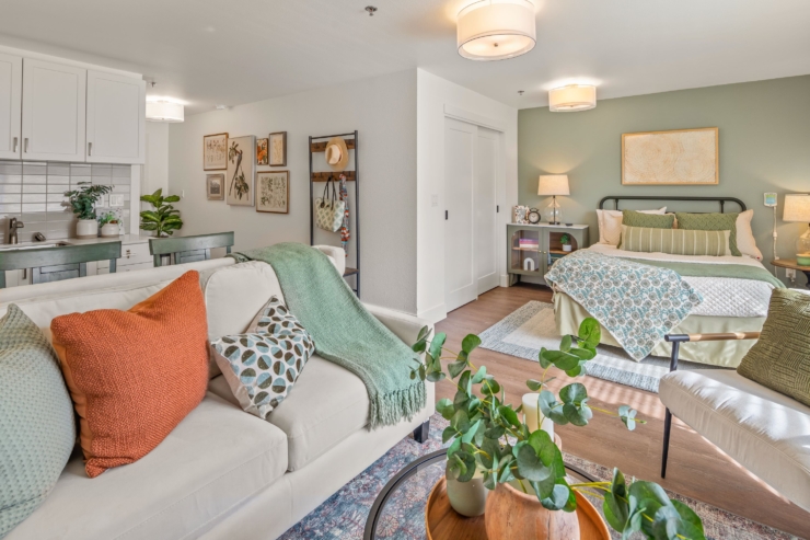 A cozy, inviting living space featuring soft furnishings, warm colors, and personal touches, perfect for fostering community and comfort.