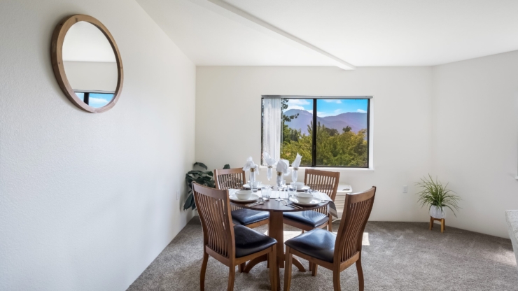 A bright dining area with a scenic view, inviting warmth and community for shared moments.