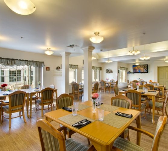 A welcoming dining area filled with natural light, inviting tables, and cheerful decor, perfect for community gatherings.