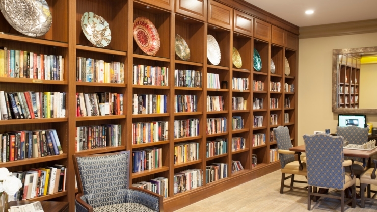 A welcoming library filled with books, comfortable seating, and a vibrant atmosphere for community gatherings.