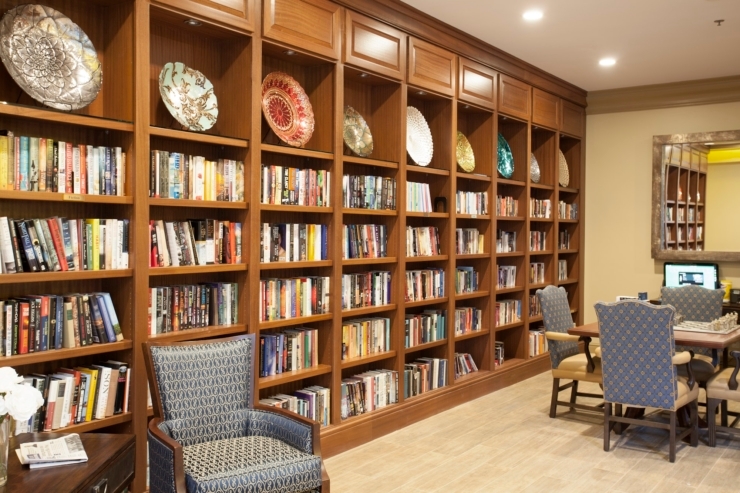 A welcoming library filled with books, comfortable seating, and a vibrant atmosphere for community gatherings.