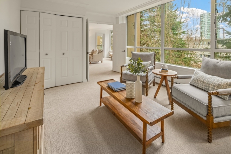 Bright and inviting, this serene living space fosters community and comfort with lovely views.