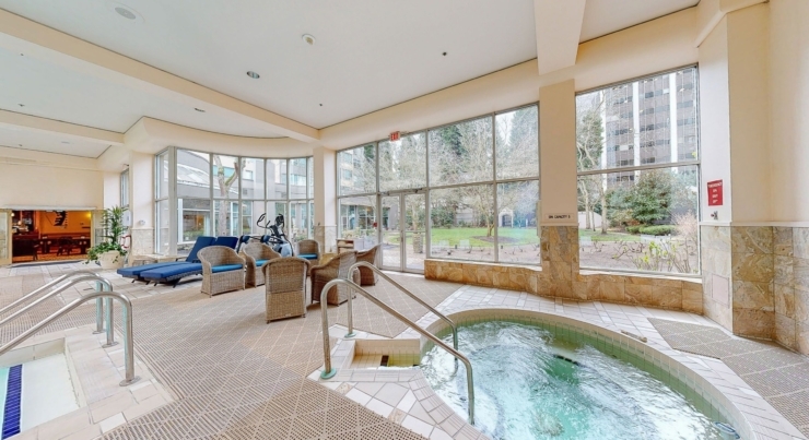 Bright, inviting space featuring a relaxing spa area, surrounded by lush greenery and community comfort.