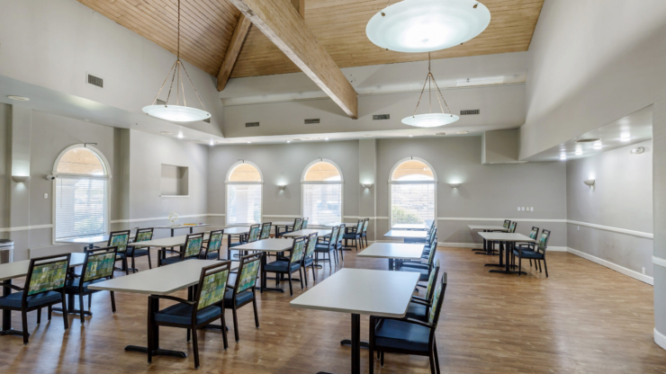 Bright, inviting space with large windows and comfortable seating, perfect for community gatherings.