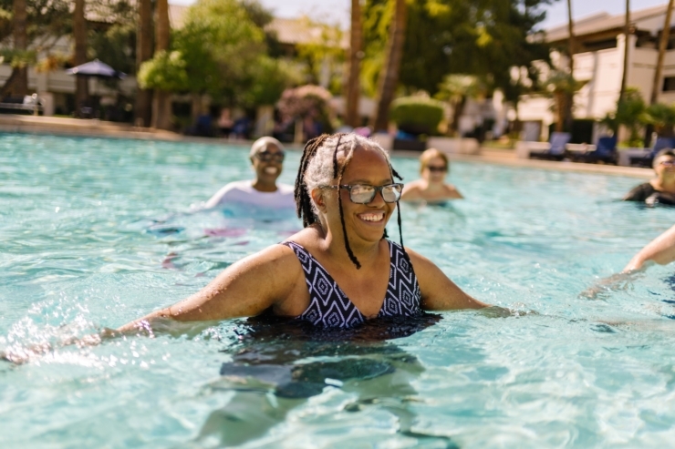 Seniors enjoy a refreshing swim together, radiating joy and community in a serene pool setting.