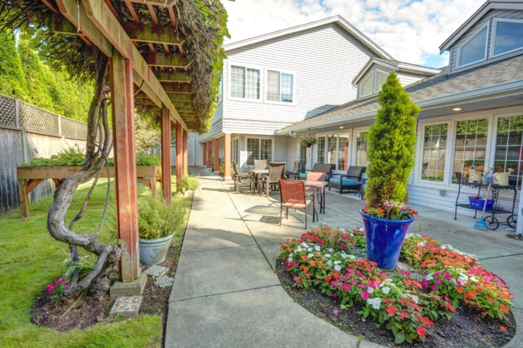 A welcoming garden pathway adorned with vibrant flowers invites residents to enjoy serene outdoor moments.