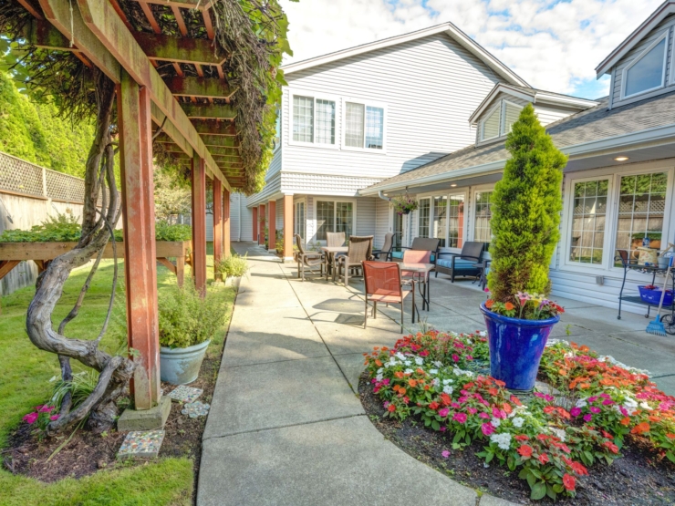 A welcoming garden pathway adorned with vibrant flowers invites residents to enjoy serene outdoor moments.