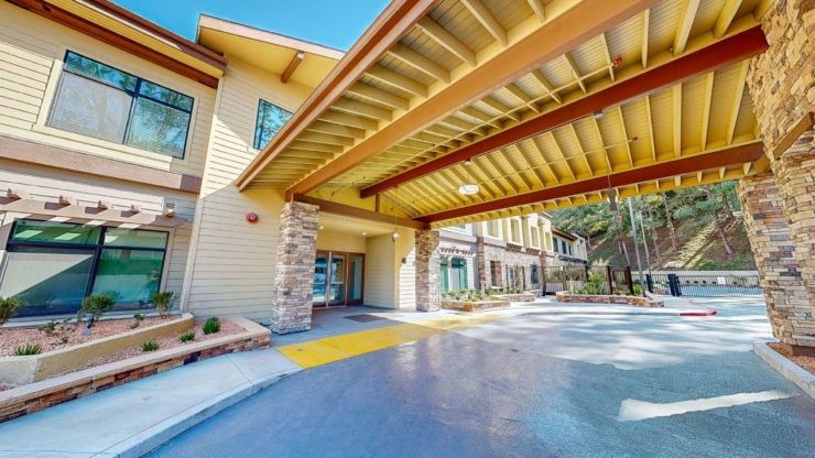 Welcoming entrance with beautiful architecture, surrounded by nature, inviting a sense of community.