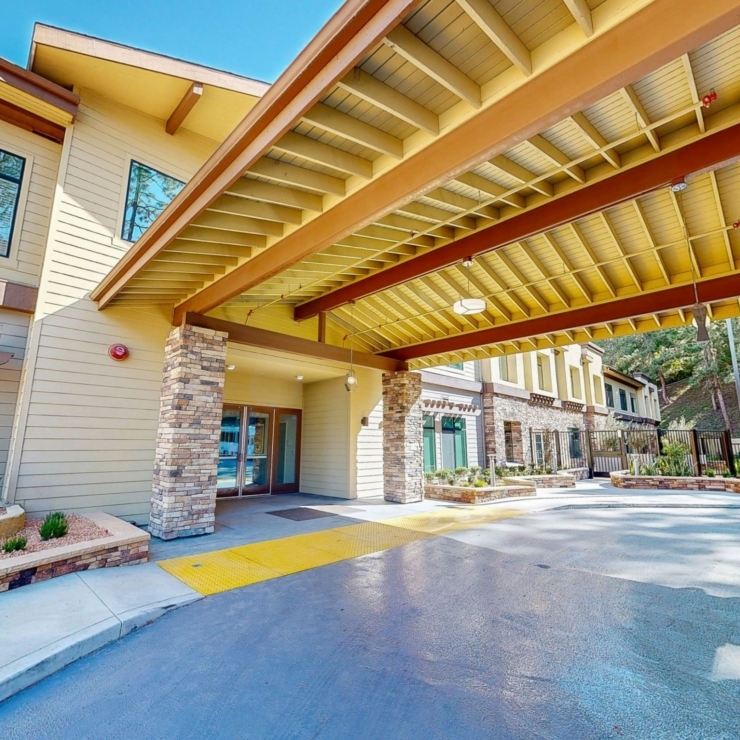 Welcoming entrance with beautiful architecture, surrounded by nature, inviting a sense of community.