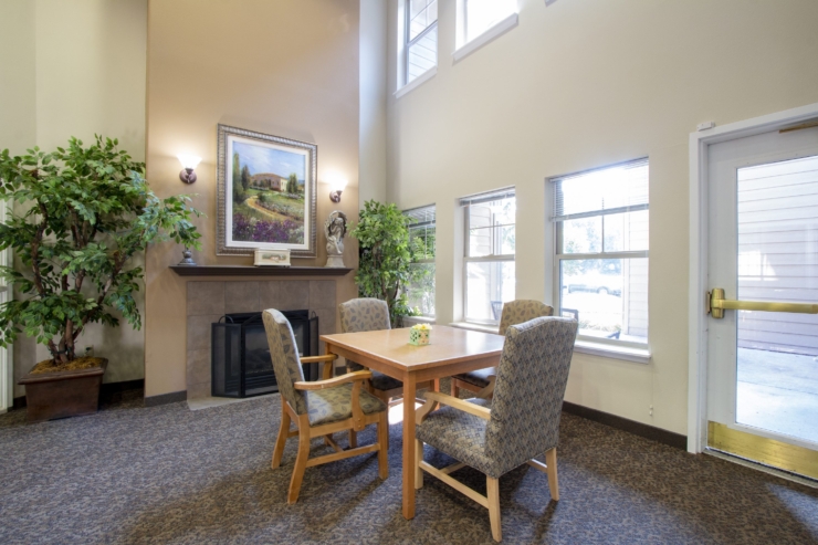 A cozy gathering space with warm lighting, inviting chairs, and a peaceful atmosphere for community connection.
