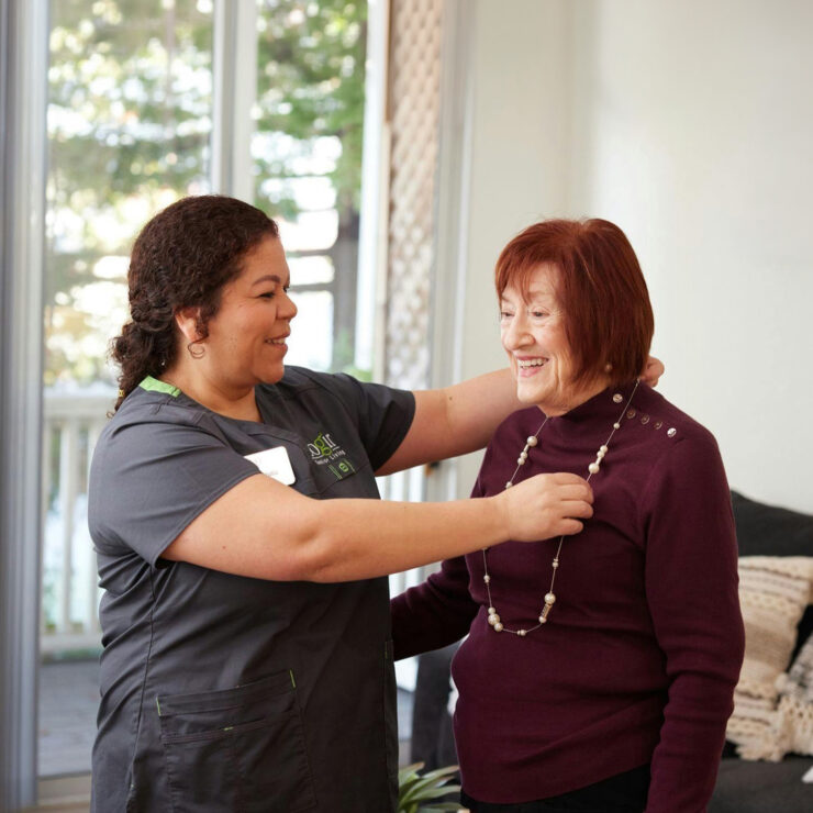 A warm interaction between caregivers and residents fosters a sense of community and belonging.