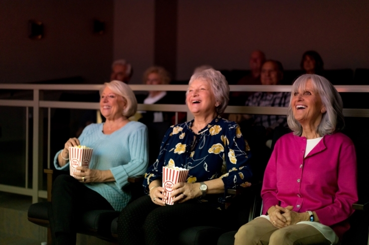 Enjoying a movie night, residents share laughter and joy, creating cherished memories together.