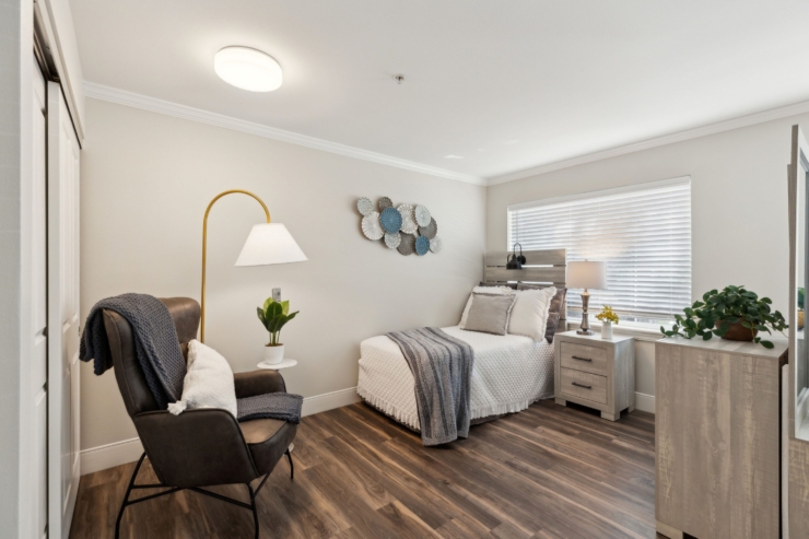 A bright, inviting bedroom with modern decor, fostering a warm sense of community and comfort.