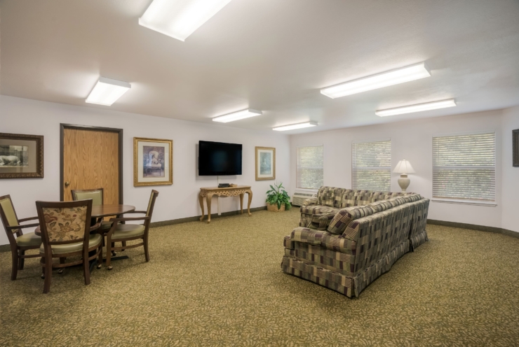 A welcoming lounge filled with comfortable seating and a dining area, perfect for socializing and relaxation.