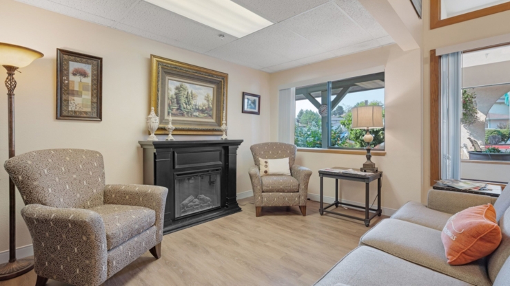 A welcoming lounge filled with light, featuring comfortable seating and serene decor for community gatherings.
