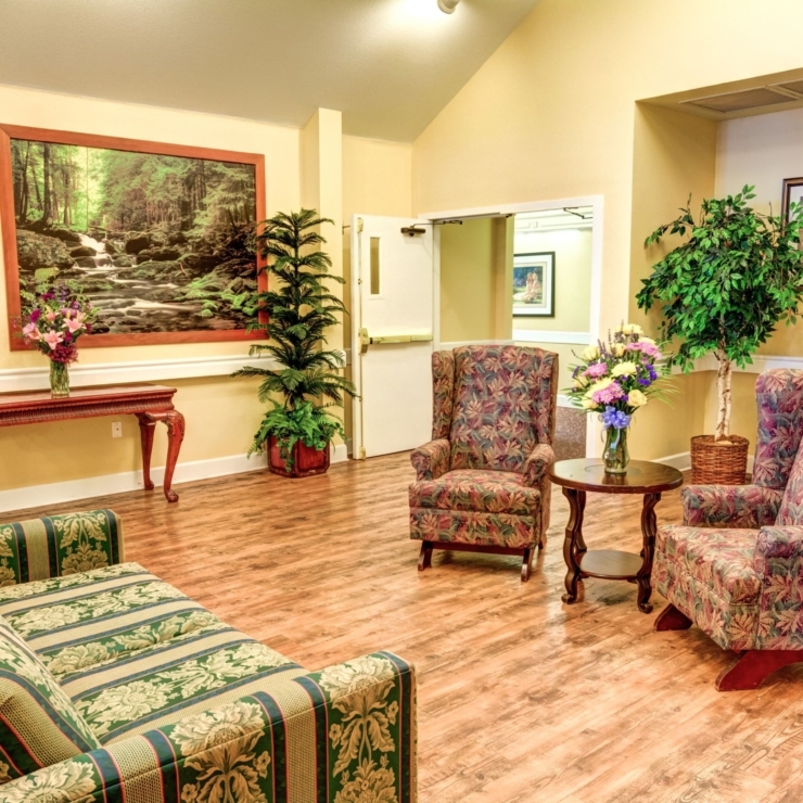 A welcoming lounge with comfortable seating, vibrant plants, and art, fostering community and relaxation.