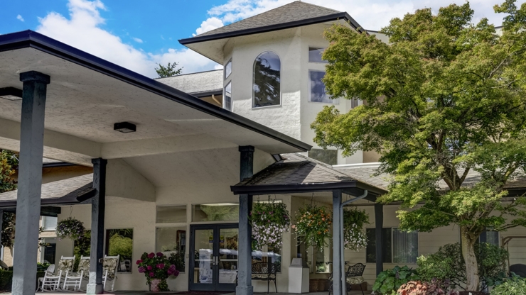 A welcoming entrance adorned with vibrant flowers, inviting a sense of community and comfort.