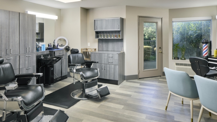 A bright, inviting salon space with stylish chairs, modern decor, and natural light, perfect for community bonding.