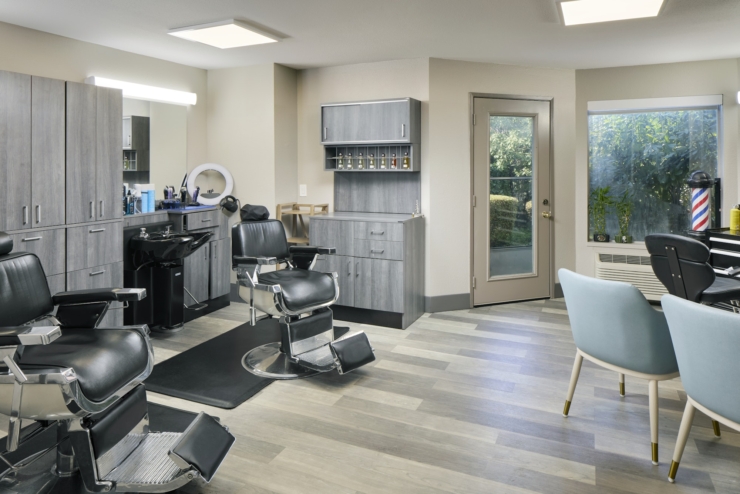 A bright, inviting salon space with stylish chairs, modern decor, and natural light, perfect for community bonding.