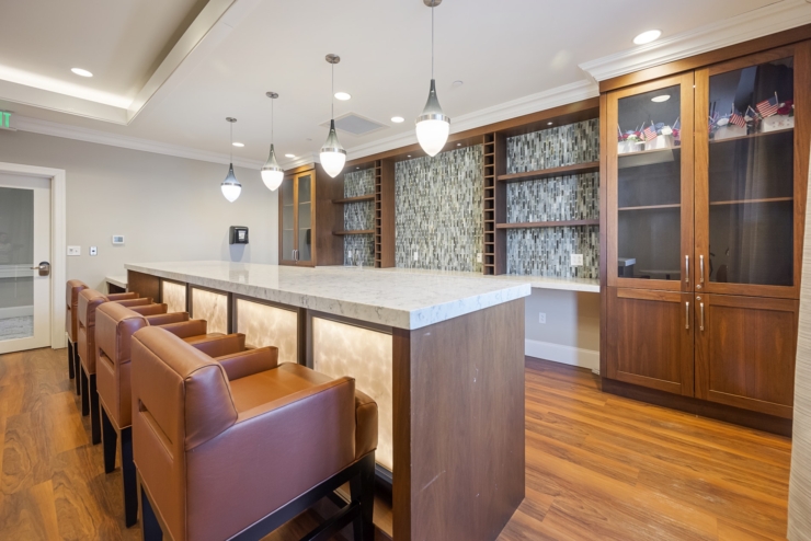 A cozy, welcoming bar area with warm lighting and comfortable seating, perfect for community gatherings.