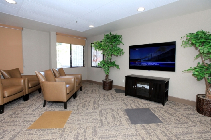 A cozy lounge area with comfortable seating, inviting warmth, and a welcoming atmosphere for residents.