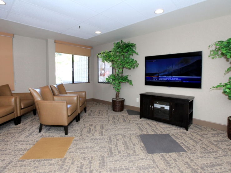A cozy lounge area with comfortable seating, inviting warmth, and a welcoming atmosphere for residents.