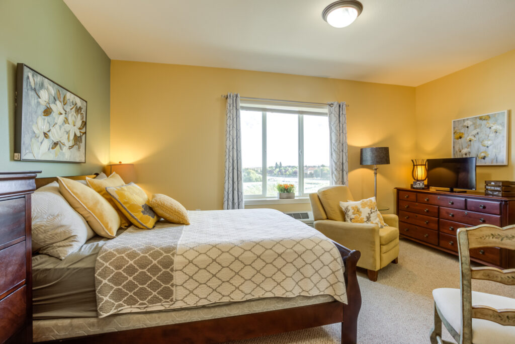 A bright, welcoming room with comfortable furnishings and a serene view, perfect for relaxation and community.