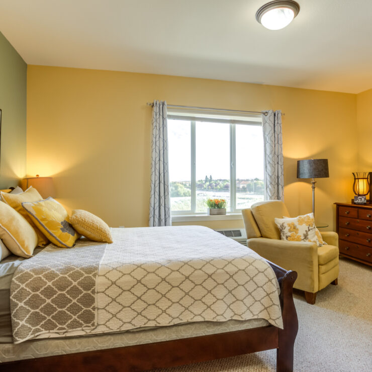 A bright, welcoming room with comfortable furnishings and a serene view, perfect for relaxation and community.