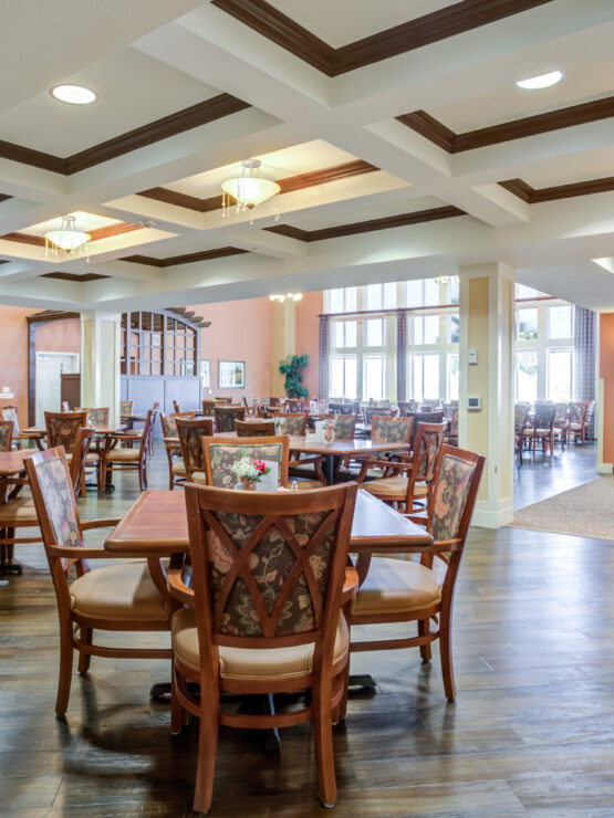 Inviting dining area with warm lighting, comfortable seating, and large windows fostering community spirit.